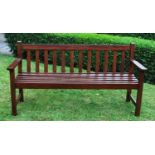 A stained hardwood slatted garden bench, upon square section legs, 153cm long