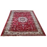 A Kashmir rug, decorated with a Sharsafi design against a red ground, 156cm x 227cm