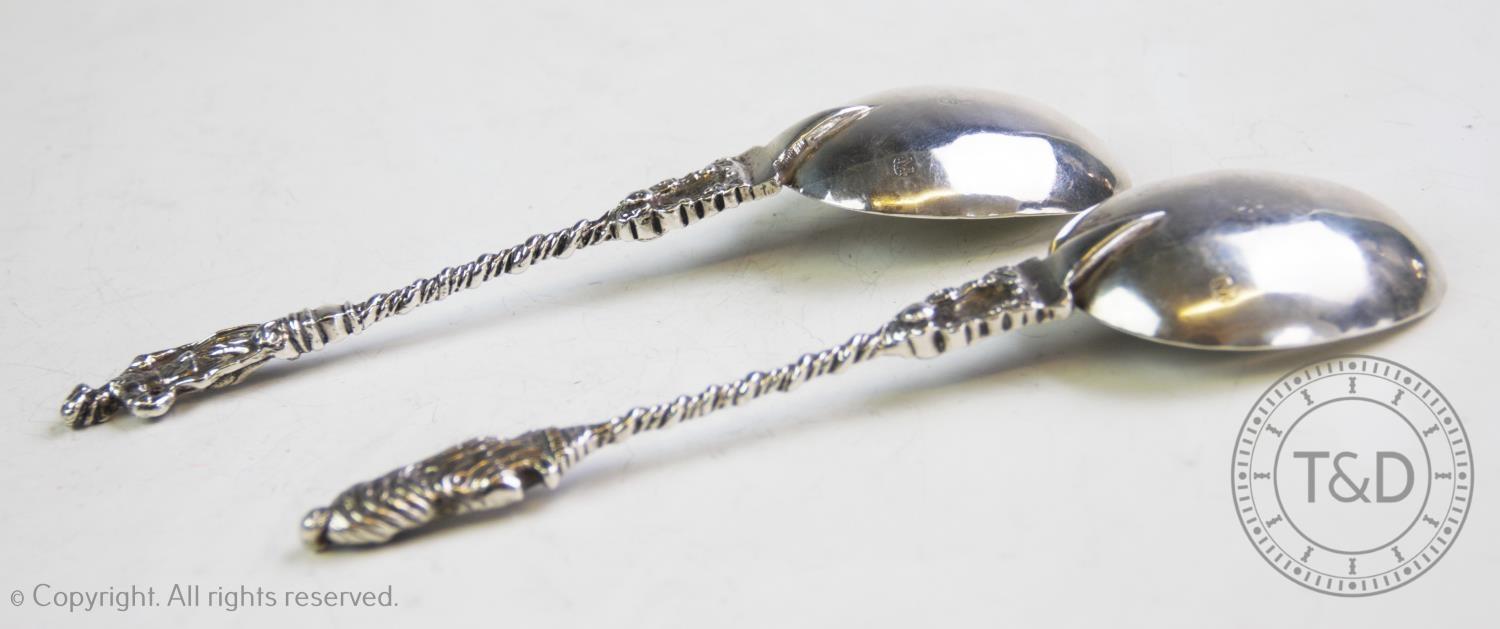 A pair of continental white metal apostle spoons, with oval bowls, chased and rope-twist stems and - Image 2 of 2