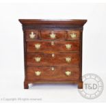 A George III mahogany chest of drawers, with a Greek key pattern cornice above a blind fretwork