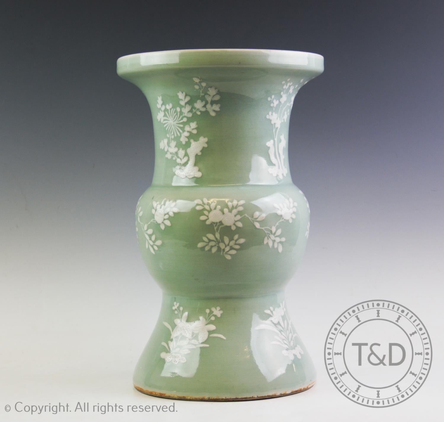 A large Chinese porcelain celadon glazed vase, of archaic gu form, decorated with sprigs of