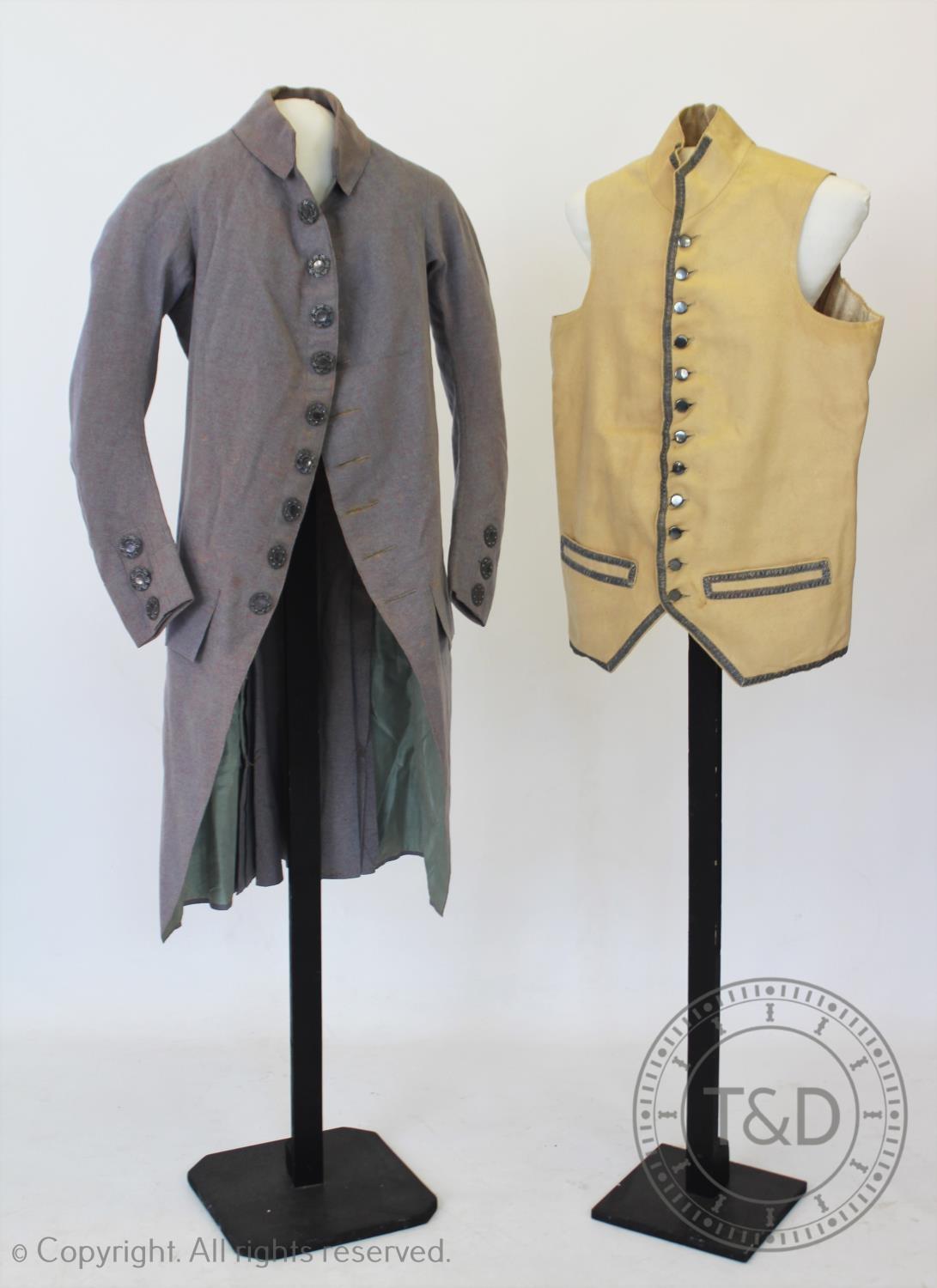 A marled lavender wool frock coat, circa 1790, with pierced silvered metal buttons to front, cuffs