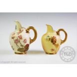 Two Royal Worcester blush ivory flat back miniature jugs, each decorated with hand painted floral