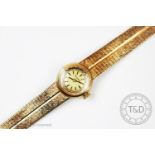 A lady's Bulova 9ct gold wristwatch, London 1965, the gilt face with black batons and textured