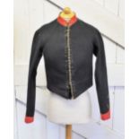 An early 20th century Royal Artillery dress mess jacket, the navy jacket lacking trimmings with
