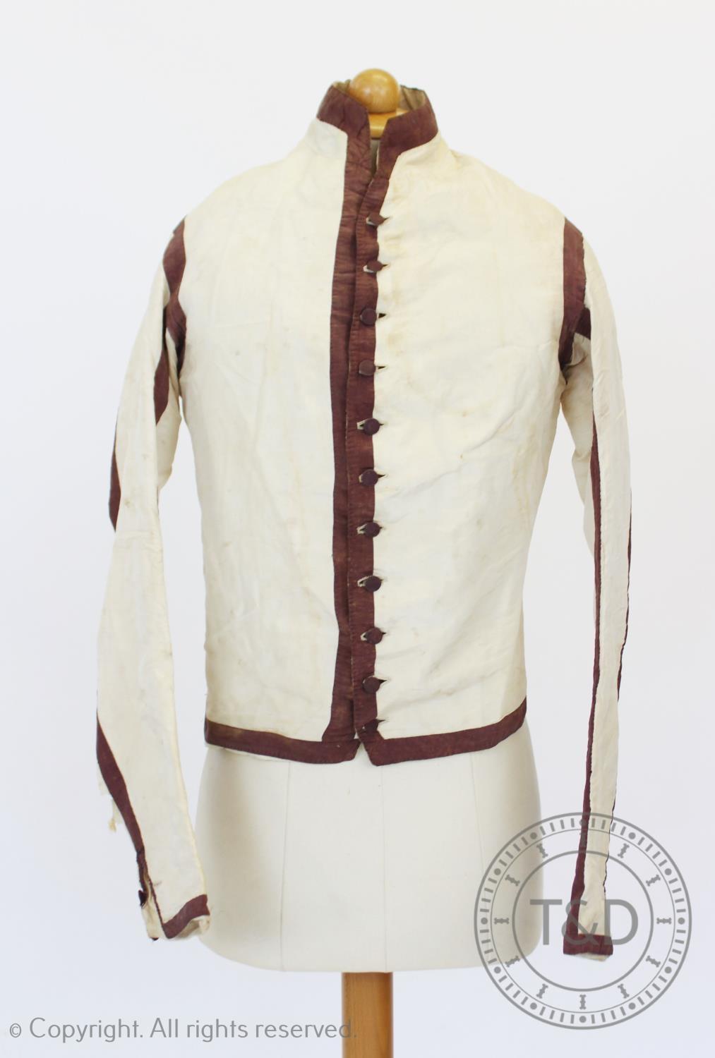 An ivory silk taffeta sleeved waistcoat or jacket, circa 1810, boldly banded and edged in dark plum, - Image 2 of 5