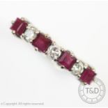 A ruby and diamond seven stone half eternity ring, the four square cut rubies interspersed with