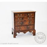 A marquetry inlaid burr walnut bachelors type chest, possibly converted from a piano, with two short