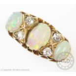 A seven-stone opal and diamond 18ct yellow gold ring, the three graduated opals interspersed with