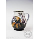 A Moorcroft jug of small proportions, decorated with the ?Bramble? design by Sally Tuffin,