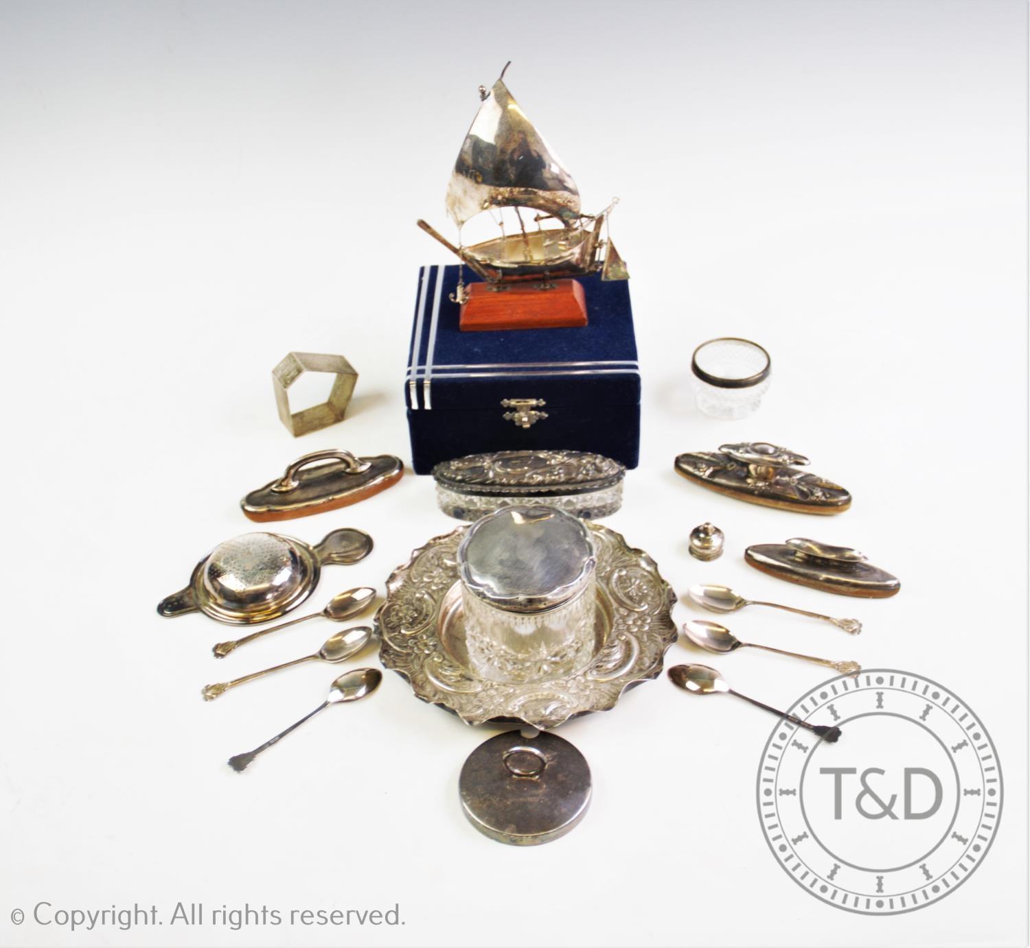 A selection of silver and silver coloured items to include, a white metal ship, on a wooden stand, a