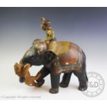 An Indian carved wood and painted figural group, early 20th century, modelled depicting a tiger