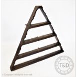 An 18th century and later assembled hanging oak plate rack, of pyramidal form with four graduated