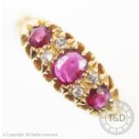 A seven stone ruby and diamond 18ct gold ring, the three graduated rubies interspersed with four