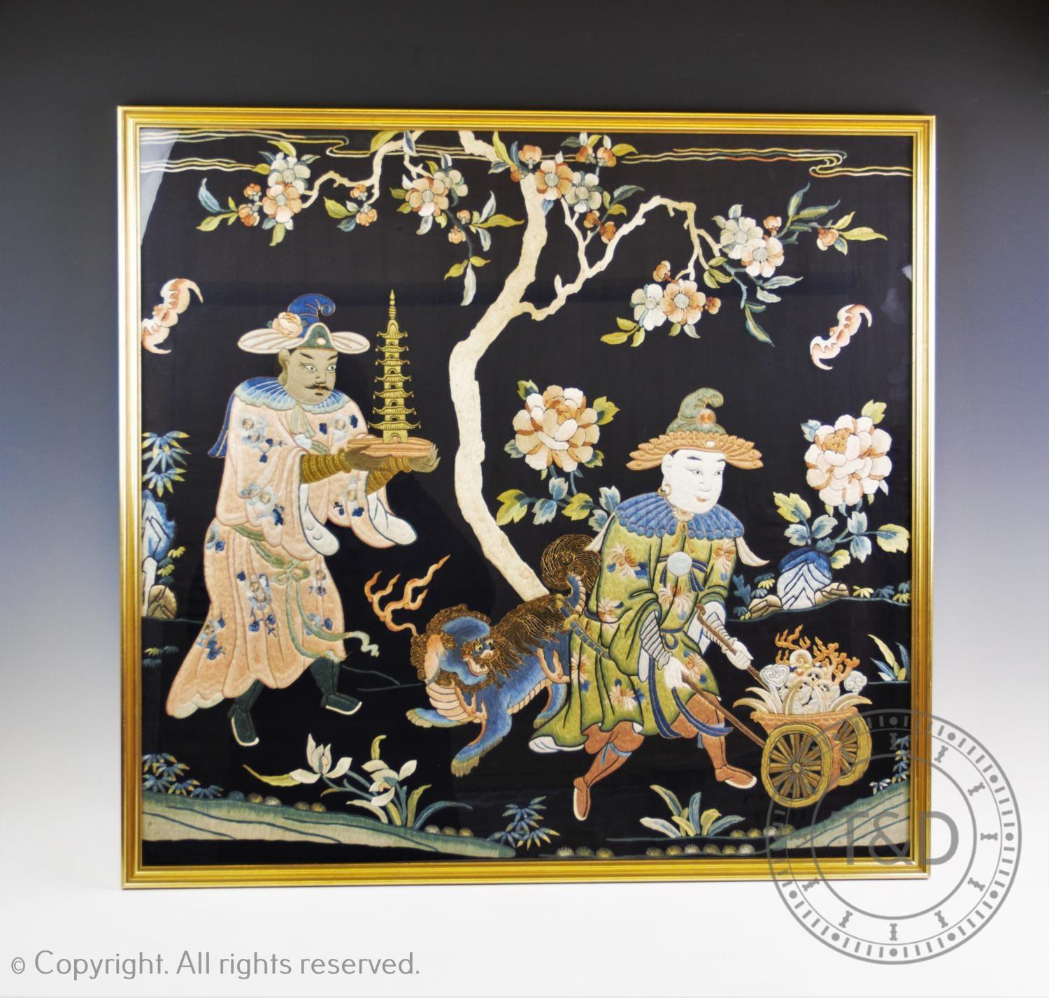 A late 19th century Chinese silk work panel, depicting a figure presenting an ivory pagoda, a dog of