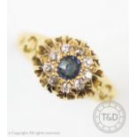 An early 20th century sapphire and diamond 18ct yellow gold cluster ring, central mixed cut blue