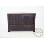 An 18th century oak mule chest, the rectangular moulded plank top concealing a fitted candle box ,