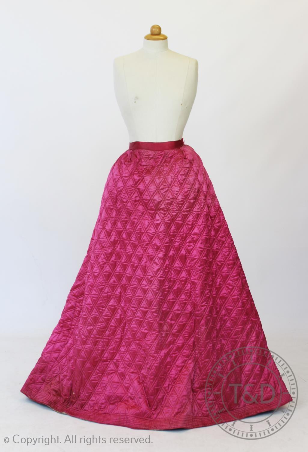 A fuscia silk quilted petticoat, circa 1845, with diamond quilted detail to the front and back and