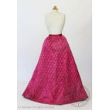 A fuscia silk quilted petticoat, circa 1845, with diamond quilted detail to the front and back and