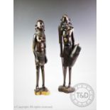 Two tribal African carved hardwood figures of large proportions, modelled as a male and female