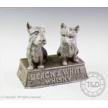 A vintage cast metal 'Black and white whisky' advertising group, modelled as two terriers upon a