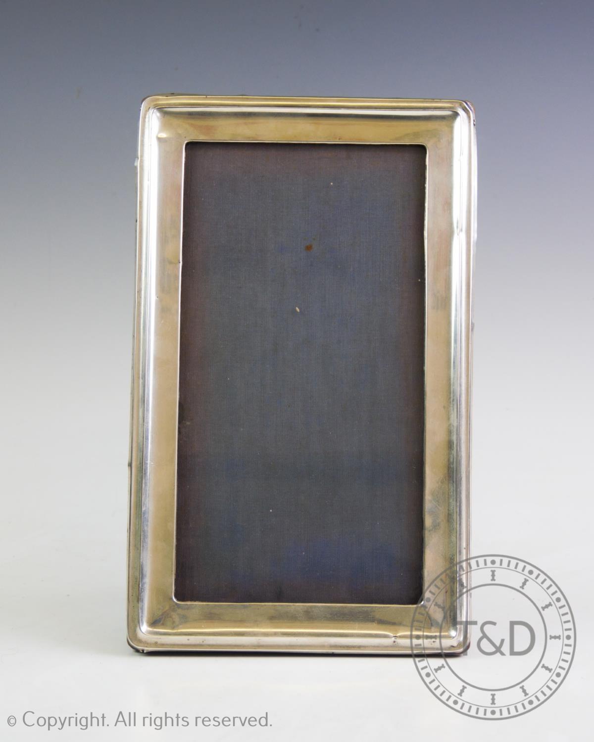 A silver photograph frame, A & J Zimmerman, Birmingham 1917, of rectangular form, with plain