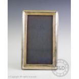 A silver photograph frame, A & J Zimmerman, Birmingham 1917, of rectangular form, with plain