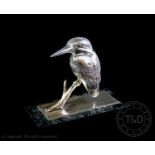 A white metal model of a kingfisher, mounted on a silver base plate, plate hallmarked London 1980,