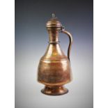 An Afghani copper ewer of large proportions, the conical ewer with hinged cover, shaped handle and
