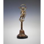 An early 20th century brass door porter, designed in the form of a winged Cupid, dressed in drapery,