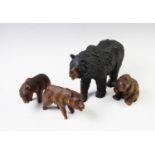 Four black forest type bears, 20th century, the largest modelled in standing position 17cm high,