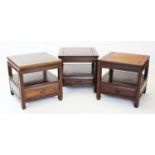 A trio of Japanese influence rosewood lamp tables, the square tables with a lower shelf and frieze
