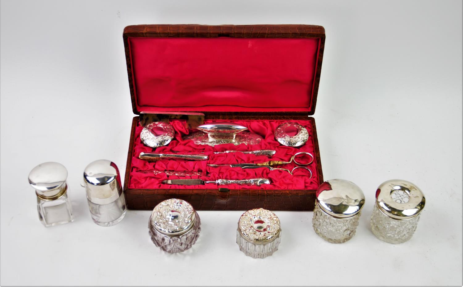 An Edwardian harlequin silver backed manicure set, comprising: two silver topped glass jars, - Image 2 of 2