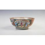 A Chinese Canton famille rose bowl, 18th century, decorated with scroll shaped reserves enclosing