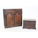 An 18th century oak wall cabinet, with a single fielded panelled door enclosing a
