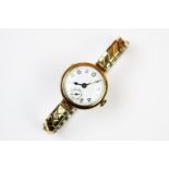 A lady's wristwatch, the circular case enclosing a white enamel dial with black numerals and