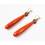 A pair of Victorian coral drop earrings, the tapered baton form coral drops set to a yellow gold