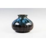 A Christopher Dresser vase of compressed ovoid form, late 19th century, decorated with drip glazes