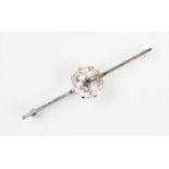 A morganite set bar brooch, the central mixed cut pale pink morganite approx. 13mm diam, set to a