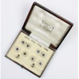 A cased gentleman's dressing set comprising rock crystal, pearl and enamel set cufflinks,