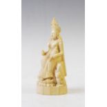 A 19th century Indian carved ivory deity, modelleded seated wearing a crown, 15.5cm high
