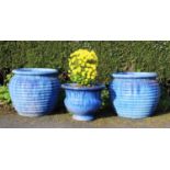 A pair of modern blue glazed stoneware planters, each of ribbed tapering form, 54cm H x 57cm D,