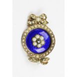 A Victorian enamel and seed pearl set cluster brooch, the central blue enamelled panel surmounted by