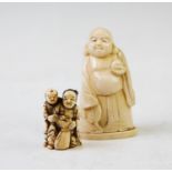 A late 19th century Japanese carved ivory netsuke, depicting a seated mother, flanked by a child,
