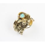 A 9ct gold opal set dress ring, the opal cabochon bezel set to an abstract design ring with