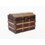 A late 19th/early 20th century domed steamer trunk, applied with wooden slats,iron swing handles and