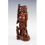 An early 20th century Chinese carved box wood figural group depicting laughing Buddha and three