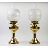 Two Victorian style brass paraffin oil lamps, with chimneys and shades, each 55cm high (2)