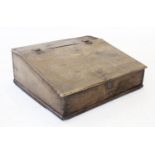 An 18th century and later oak bible box, with a hinged slope above the front panel carved with the