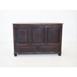 An 18th century oak mule chest, the rectangular moulded plank top concealing a fitted candle box,